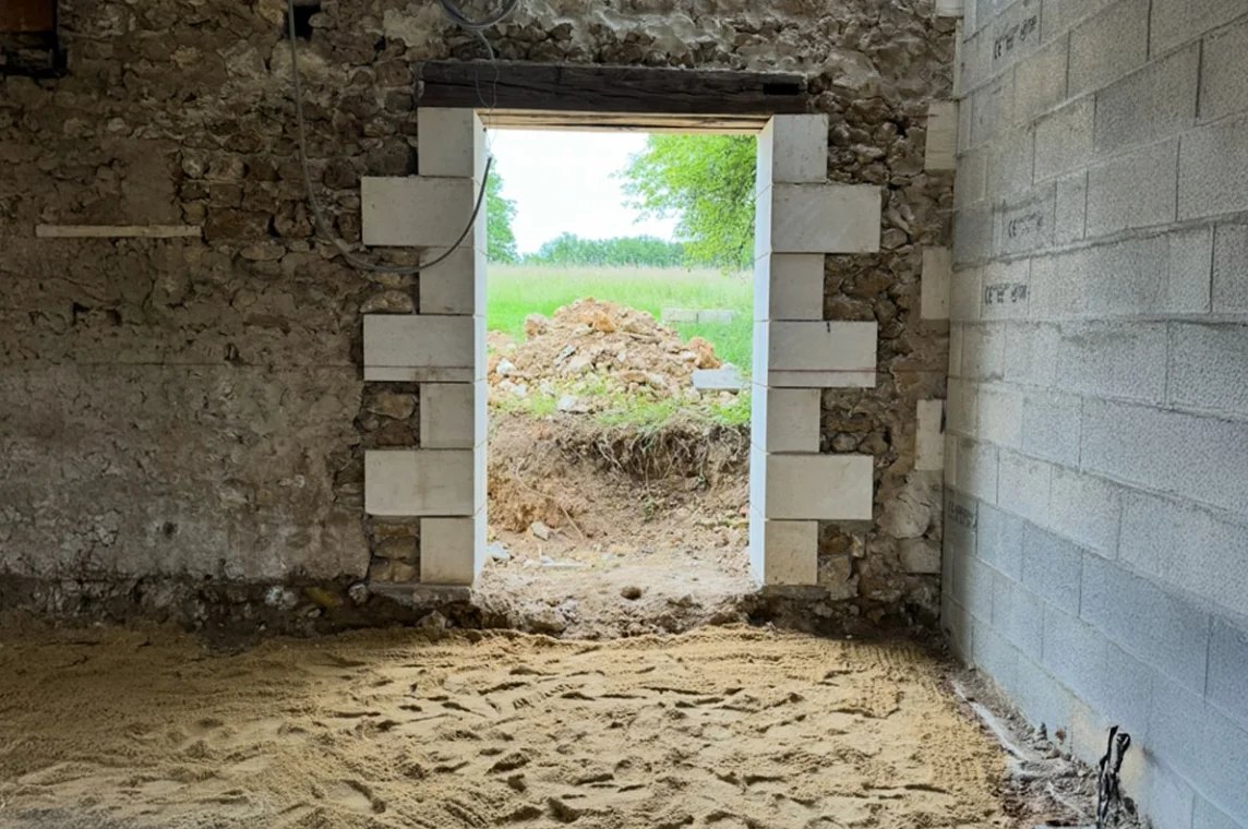 Création d'une ouverture dans un mur en moellons, avec jambages harpés en pierre