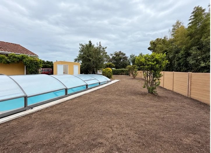 Terrain décapé et nivelé autour d'une piscine, prêt à être engazonné